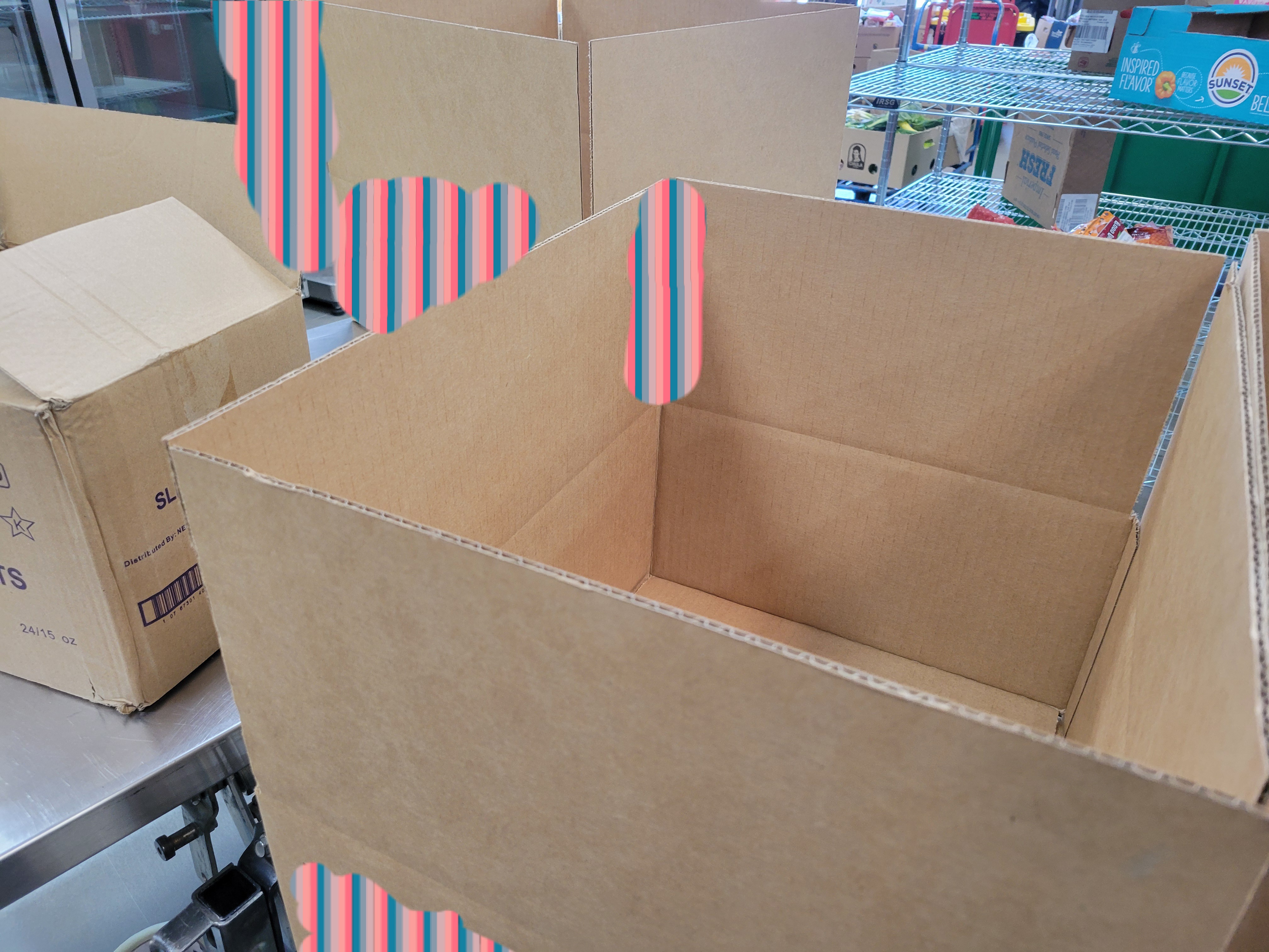 Cardboard boxes with a shelf behind it